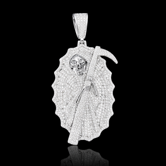 White gold Grim Reaper pendant fully set with micropavé stones, featuring a detailed skull and diamond-set scythe on a black background.